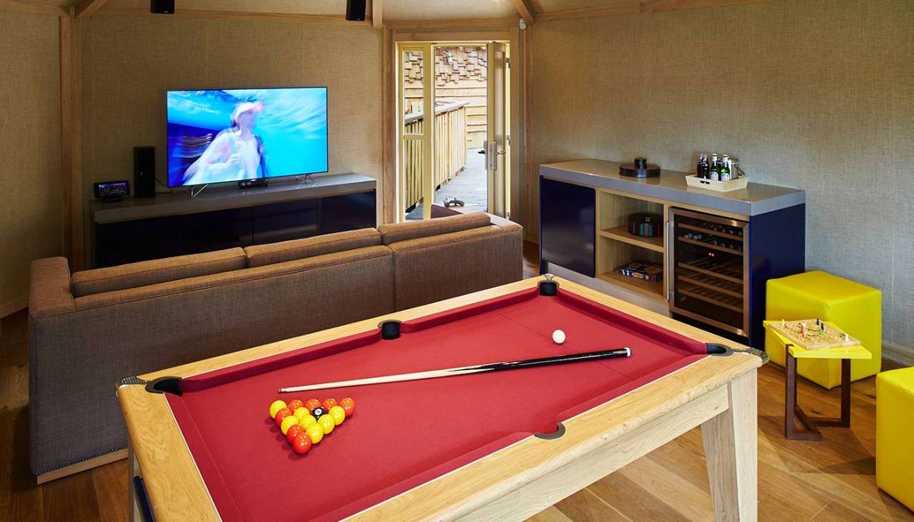 Games room with pool table, games, and TV