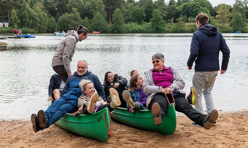 Boots delegates on a kayak having a photo taken.
