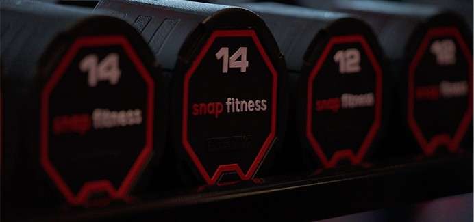 Dumbell weights on a rack.