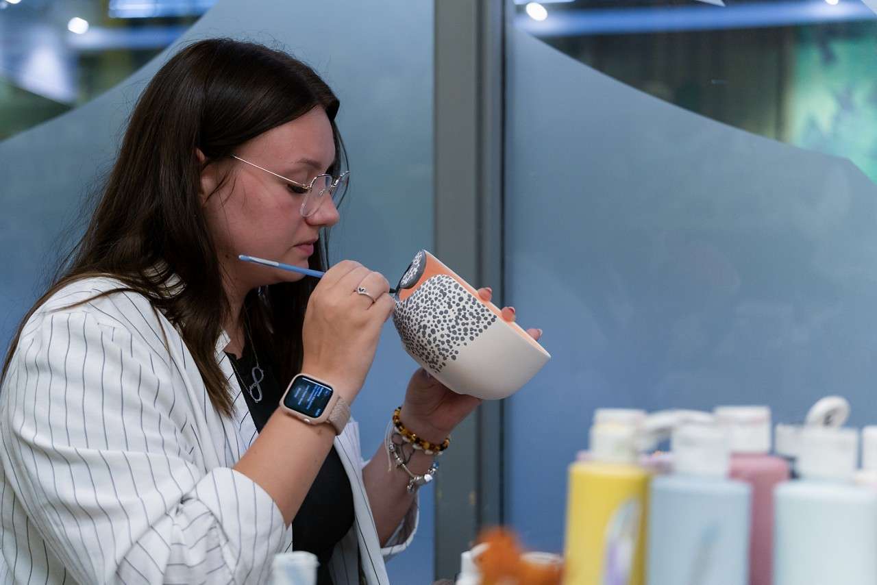 woman painting pottery