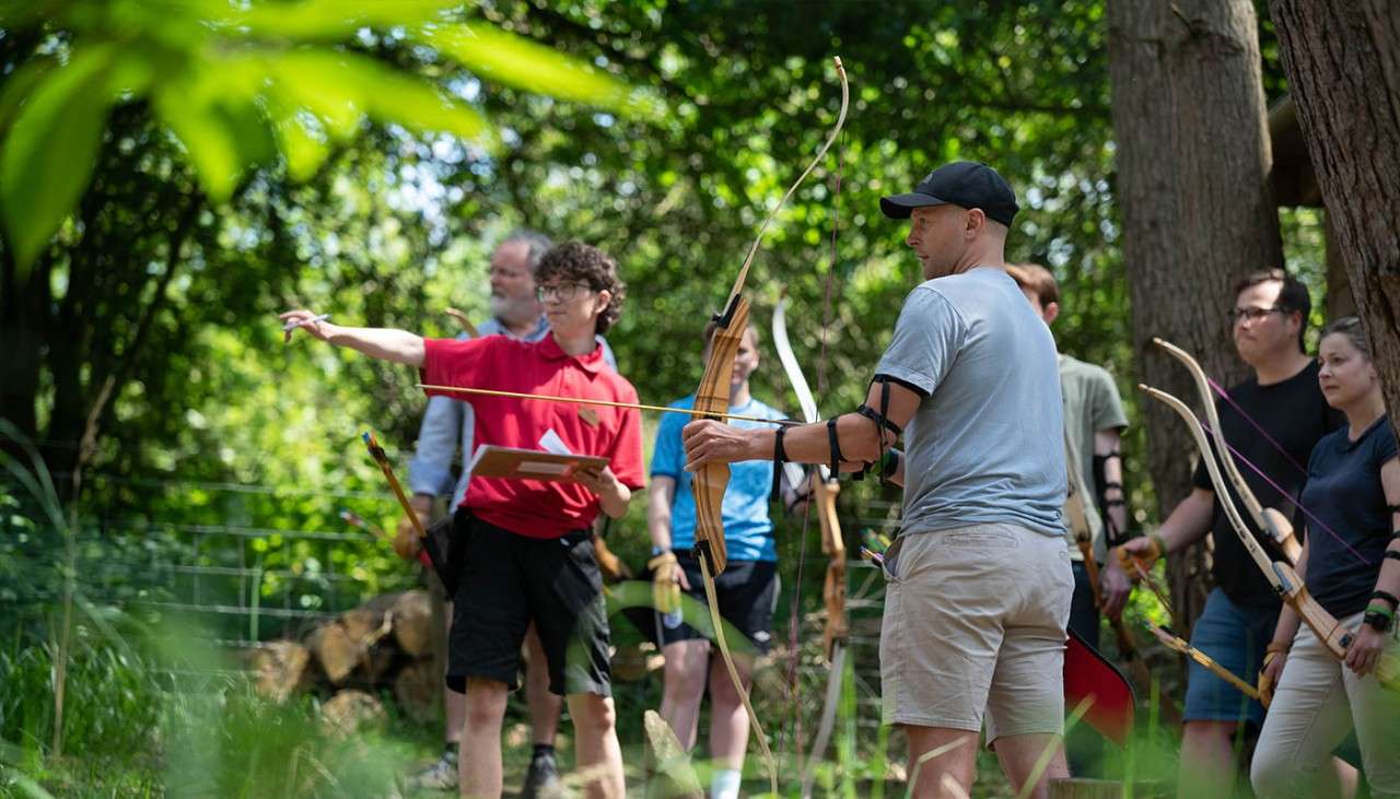 People taking part in the Archery activity.
