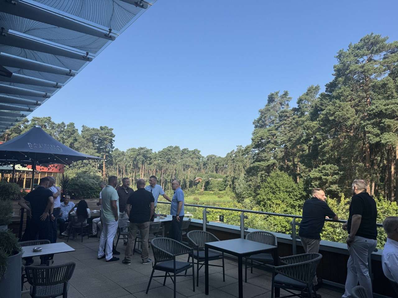 furniture village team standing outside on the terrace overlooking the forest