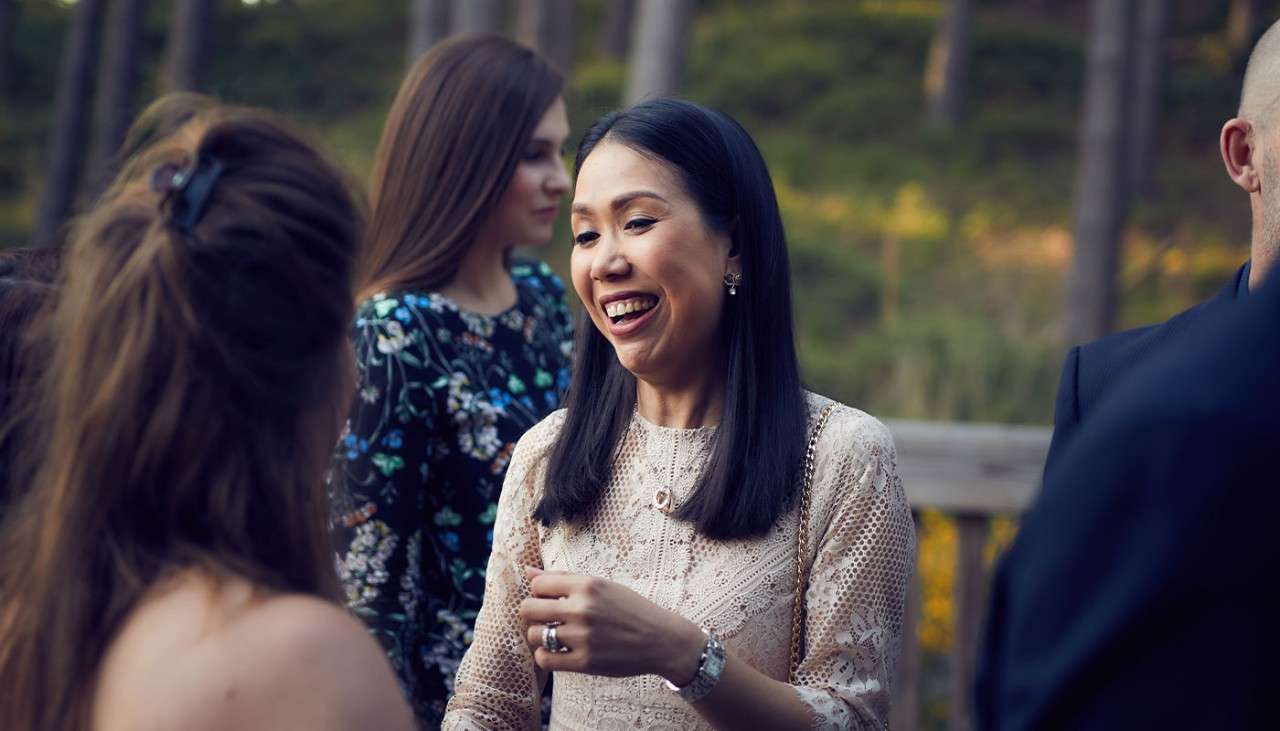 A woman laughing whilst talking.