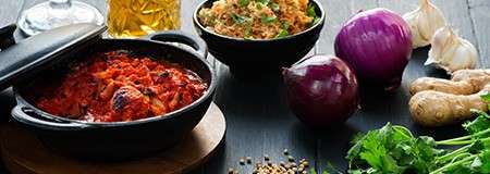 Curry served with rice surrounded by garnish