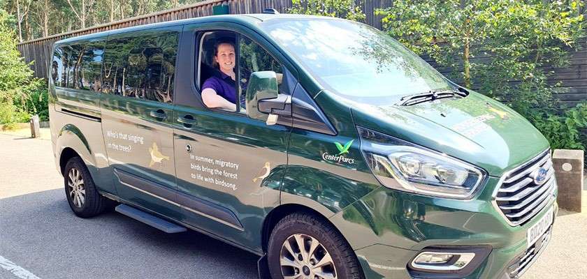 Housekeeping team driving a hybrid van.