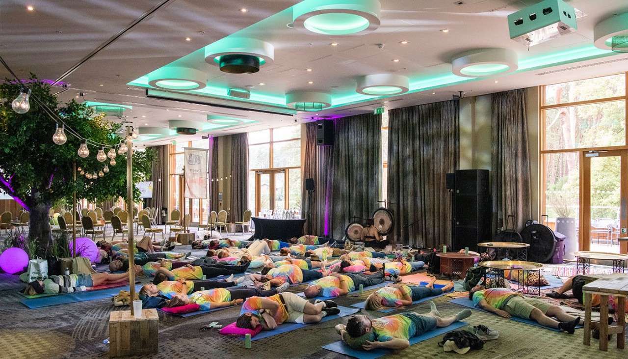 People laying on the floor as part of sound bath medititation.