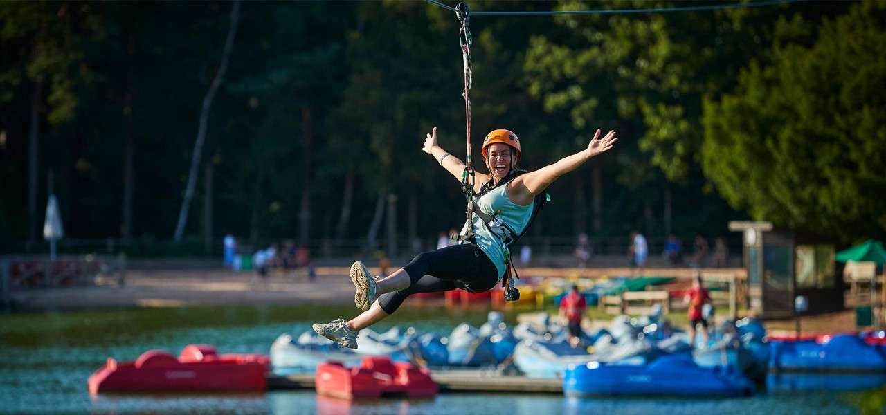 A woman going down the zip line on Aerial Adventure.