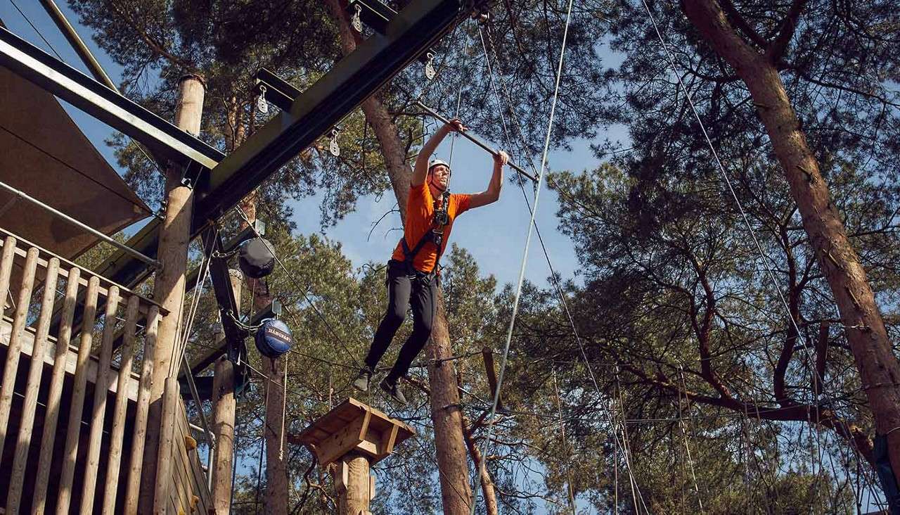 Man jumping on the leap of faith in The Drop activity