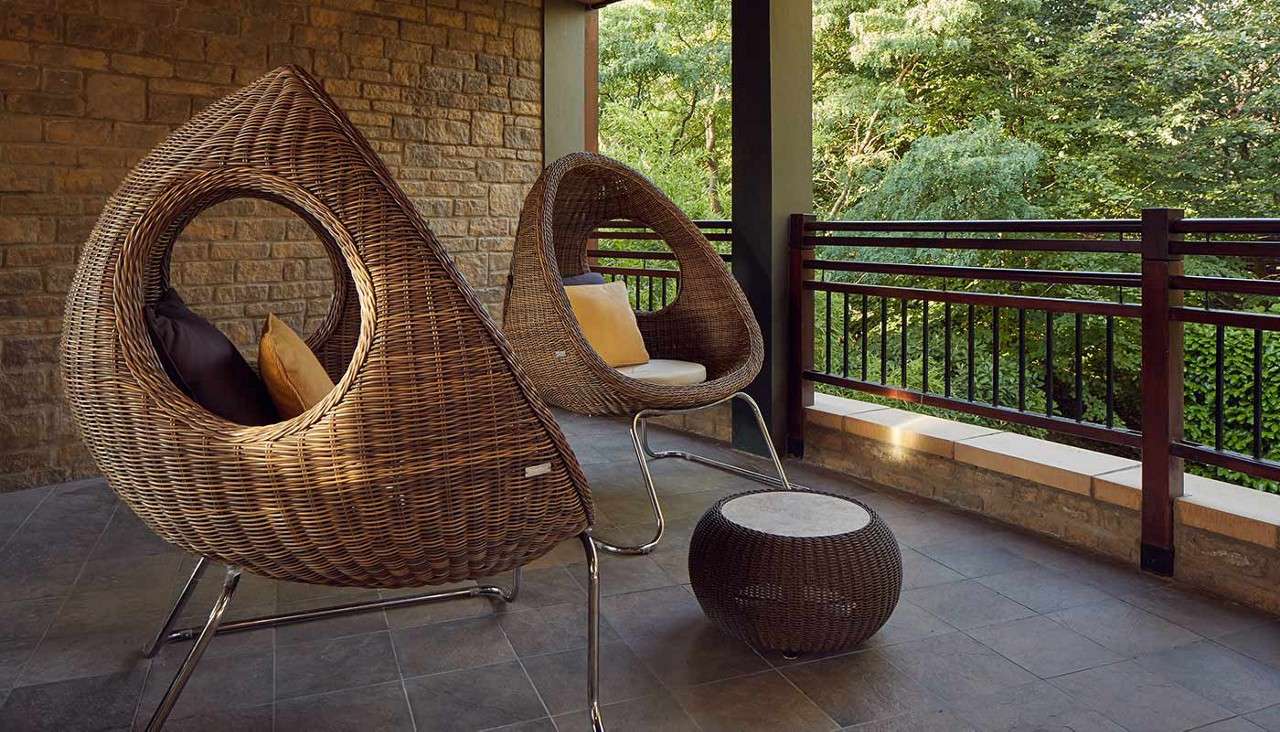 Comfy seats on an outdoor balcony at Aqua Sana Forest Spa