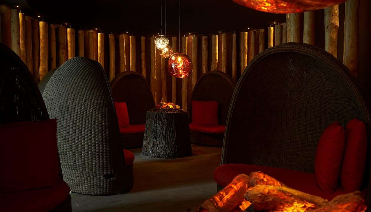 Fireside relax at Aqua Sana Forest Spa with cosy seating around fake fires