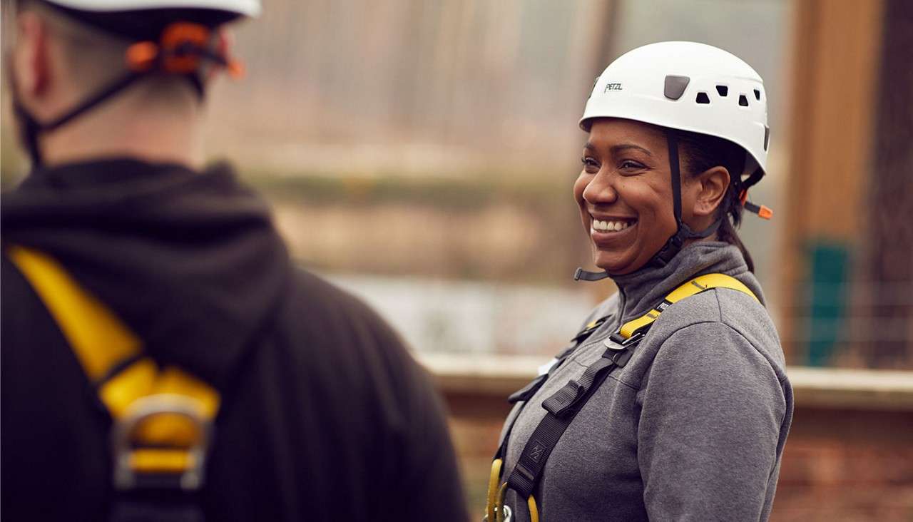 Woman getting kitted up in harness and helmet