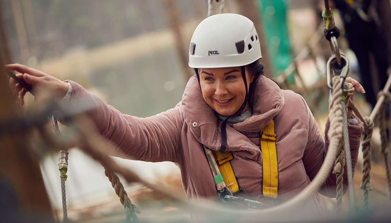 Woman starting her descent into the treetops