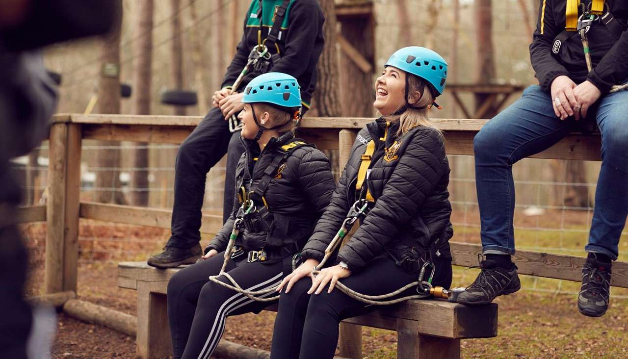 Group in their safety helmets and harness waiting to be briefed on the exciting activity ahead