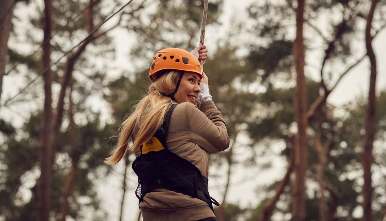 Woman soaring along a zip line