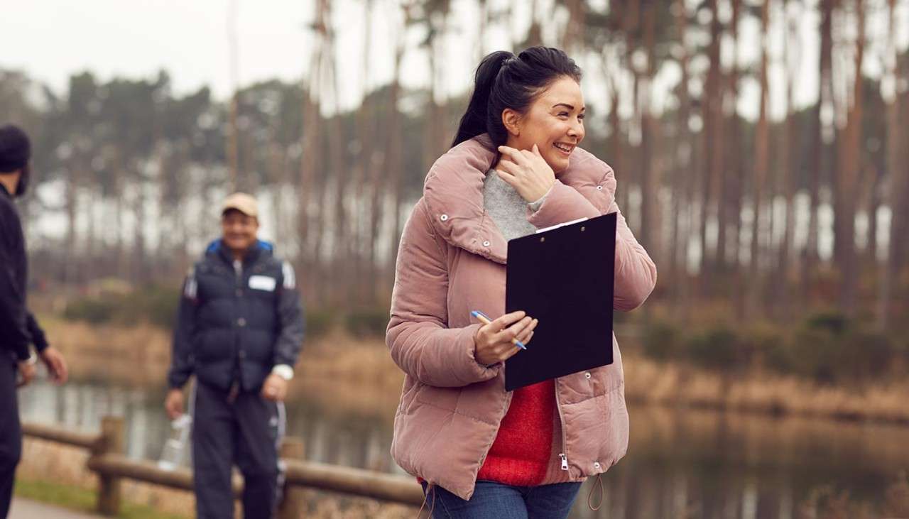 Woman walking through Center Parcs with a map