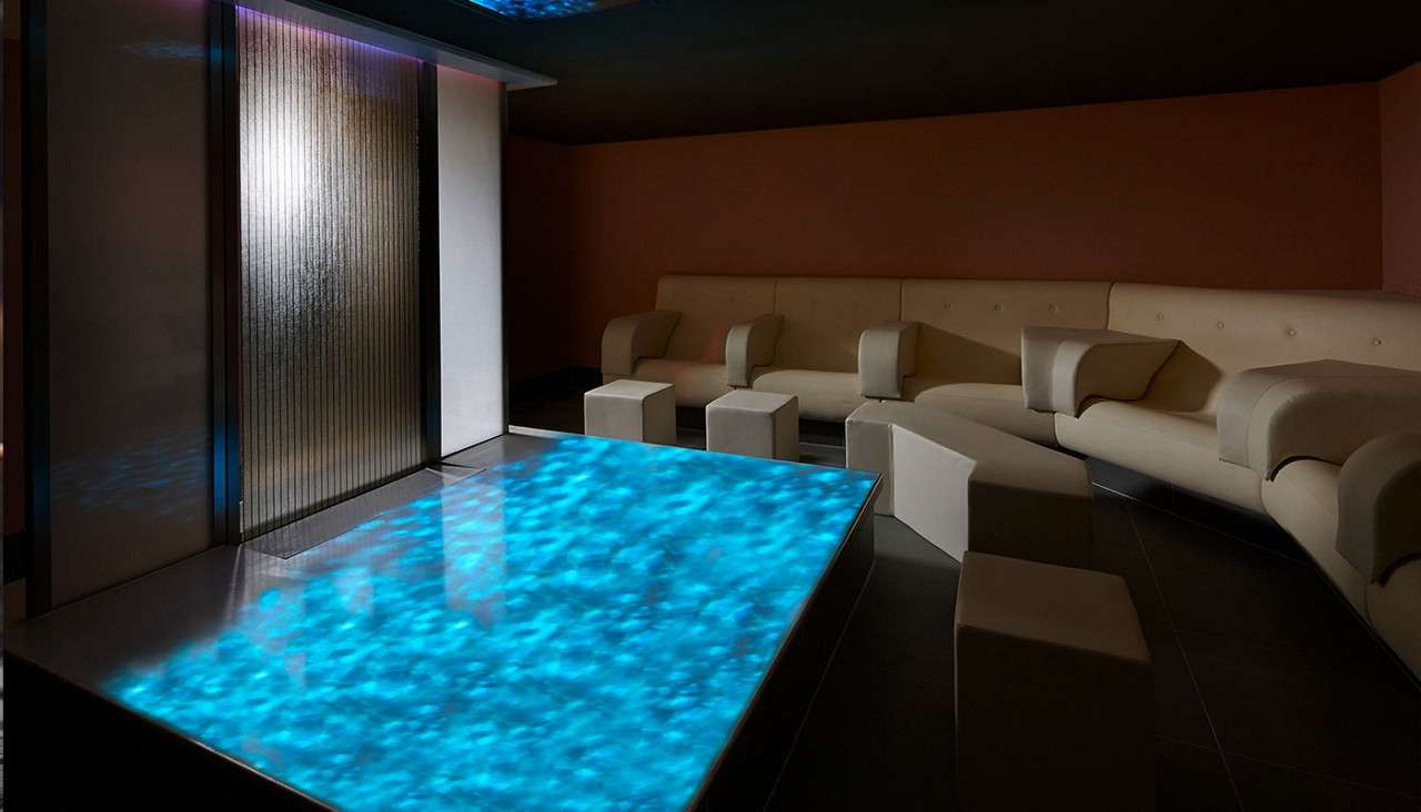 Aqua Meditation room with projected lights and comfortable seating.