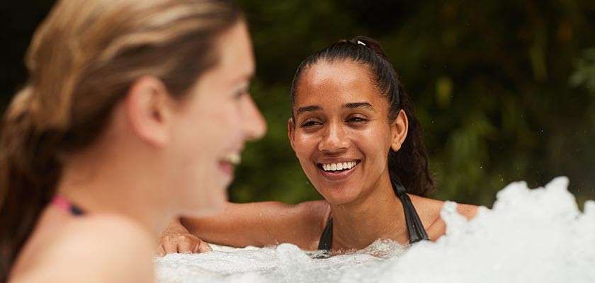 Women sat in a hot tub outside