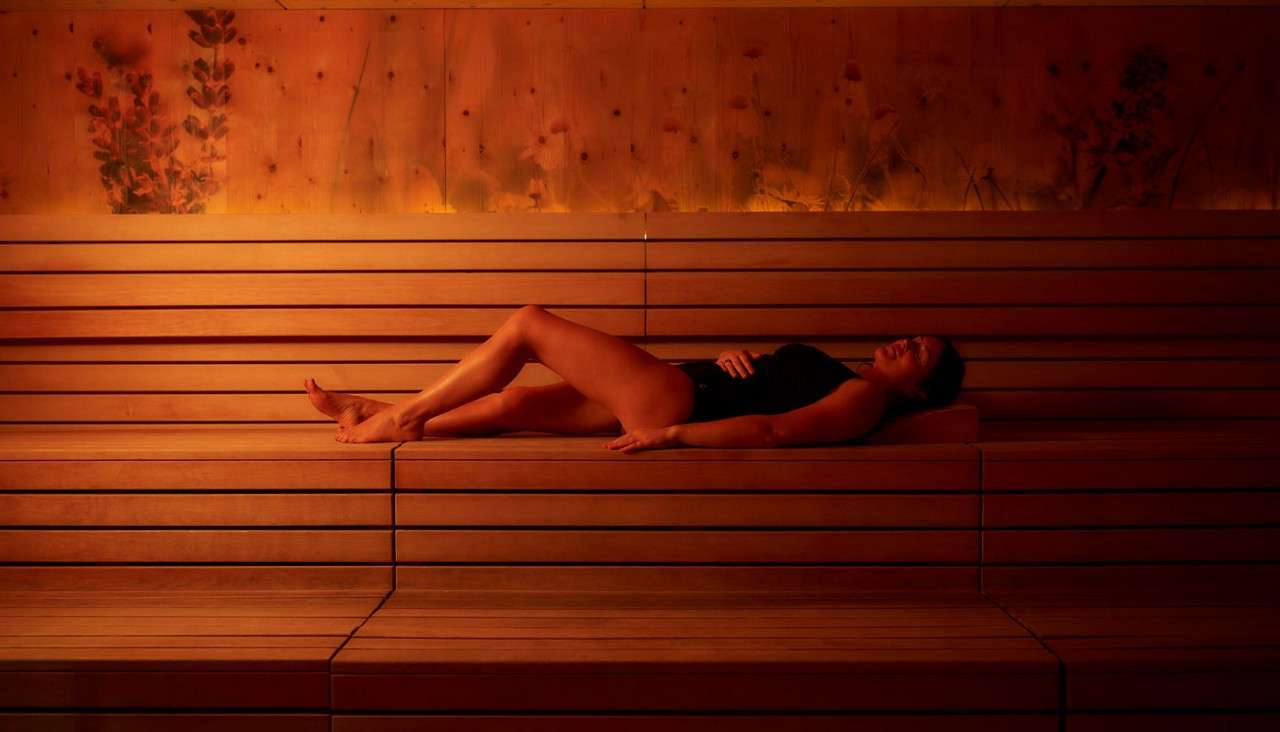 Woman laying in a relaxing Herbal Sauna