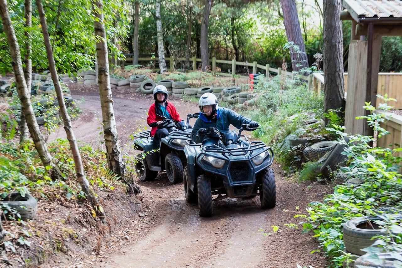 Delegates on quad bikes in the forest.